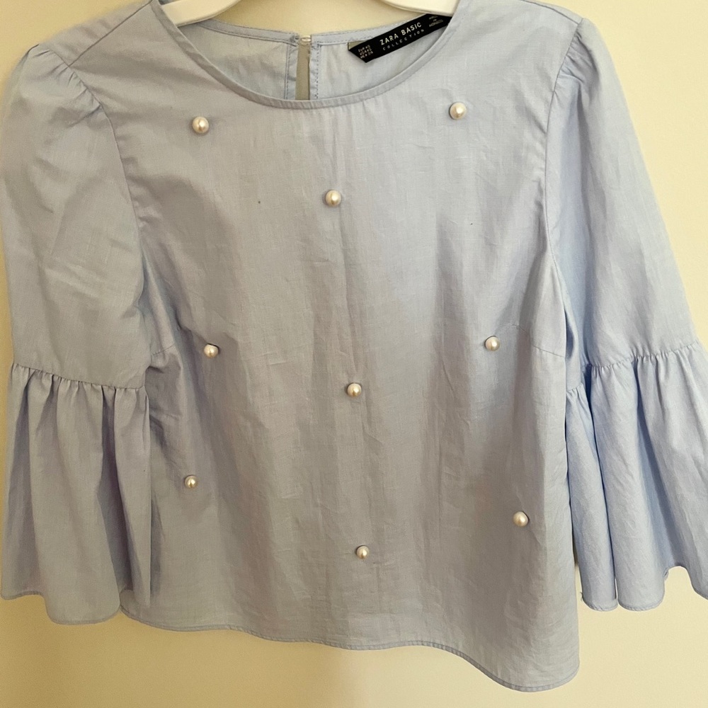 light blue blouse with pearls